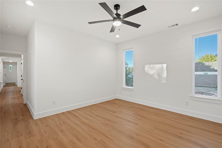 Unfurnished room with light hardwood / wood-style flooring and ceiling fan