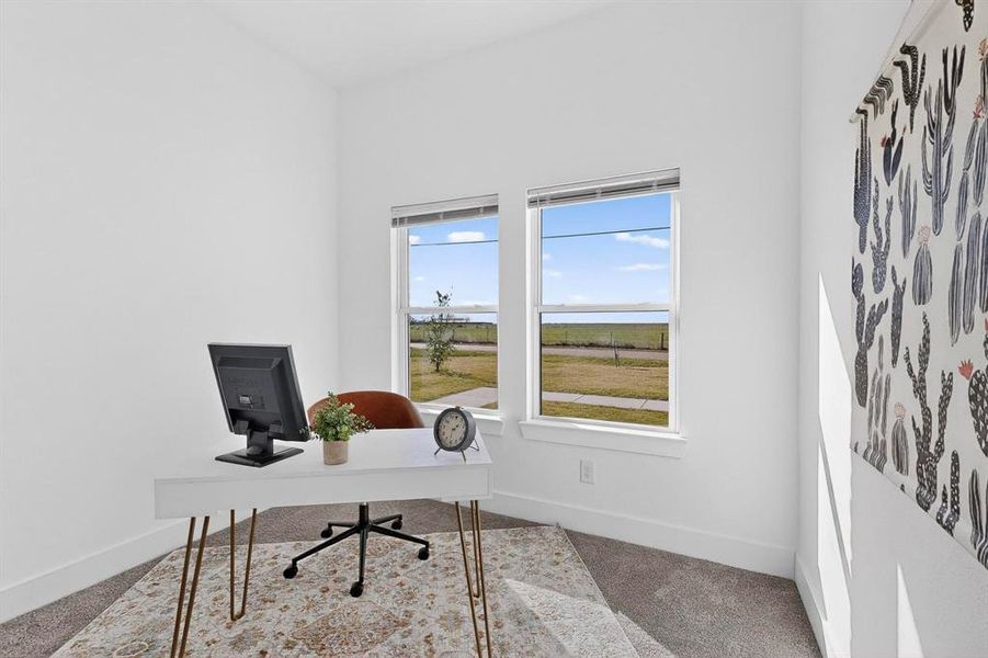 Office area with carpet flooring and baseboards