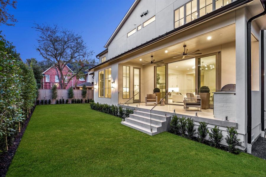 Expansive Pella windows and doors frame views of the backyard while blending interior and exterior spaces. Veranda with Coyote gas grill, vent hood, and sink. Expansive Pella windows and doors frame views of the backyard while blending interior and exterior spaces. Veranda with Coyote gas grill, vent hood, and sink.
