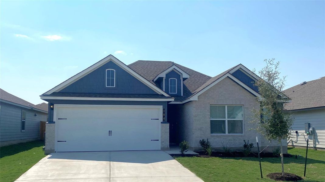 Front exterior of a new home in Eastern Wells, Jarrell, TX, highlighting curb appeal (Image 1). Front exterior of a new home in Eastern Wells, Jarrell, TX, highlighting curb appeal (Image 1).