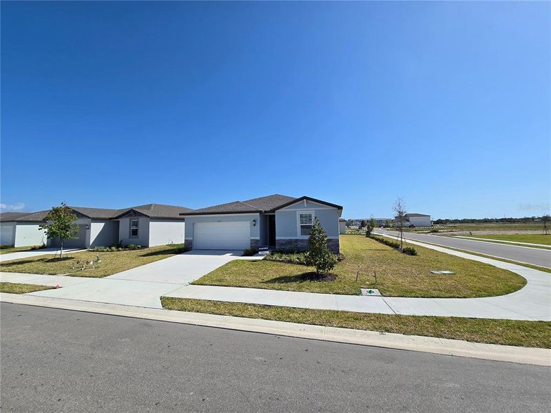 Front exterior of a new home in Magnolia Bay - Classic Series, Nokomis, FL, highlighting curb appeal (Image 15).