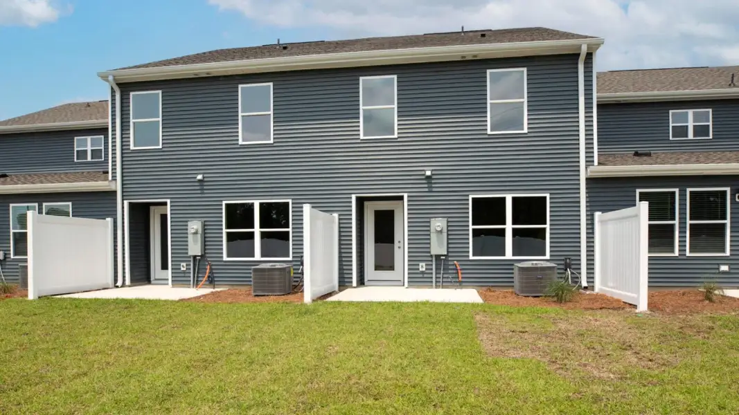 Exterior details and patio area of a home in The Townes at Cedar Hill Landing, Navassa (Image 3).