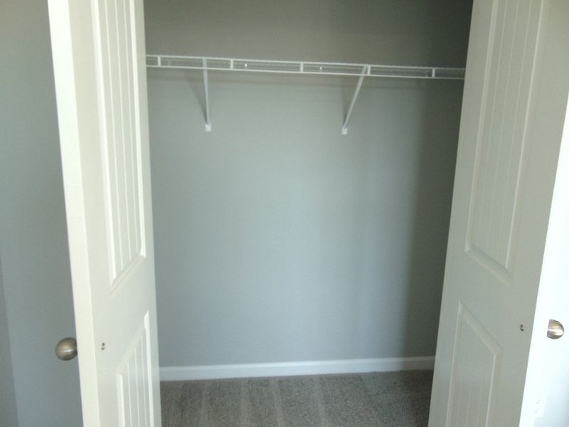 The second bedroom with large windows for that nature lighting, as well as your closet as well as a convenient rack.