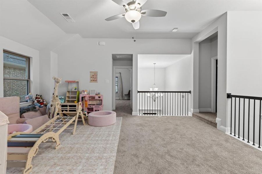 Sitting room featuring ceiling fan, carpet floors, a chandelier, and vaulted ceiling Sitting room featuring ceiling fan, carpet floors, a chandelier, and vaulted ceiling