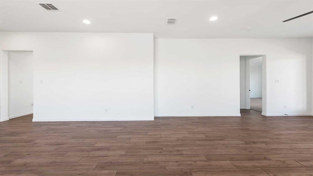 Empty room featuring dark wood-type flooring