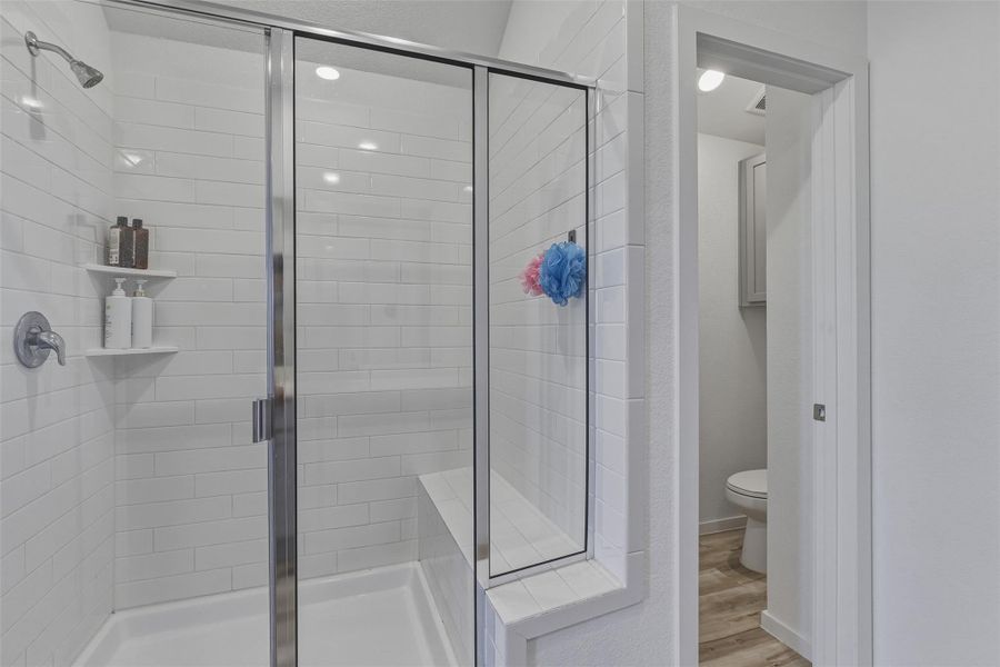 primary shower with a seat