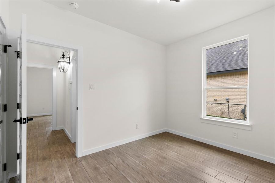 Interior room featuring wood-finish flooring and a single hung window