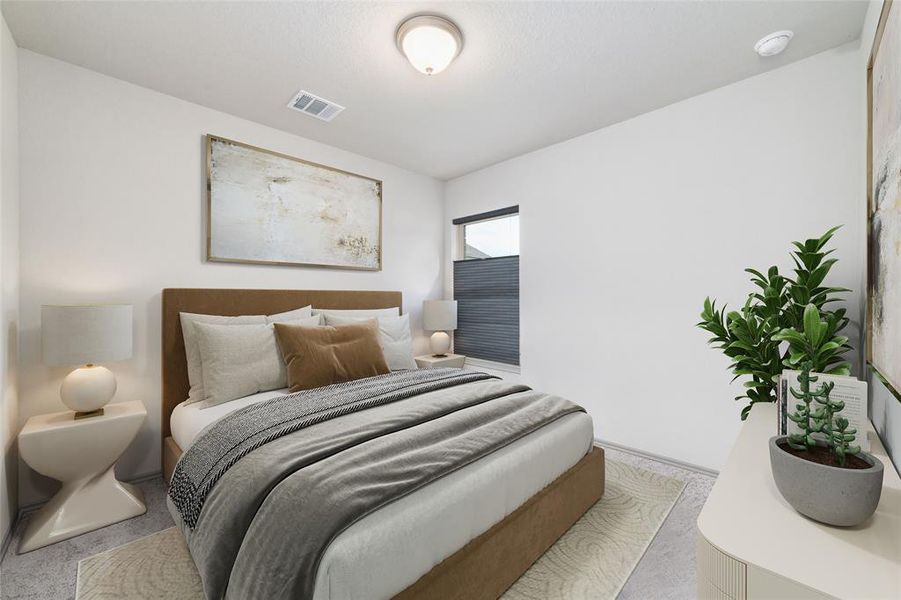 The spacious primary bedroom offers a tranquil retreat, with soft carpet underfoot and large windows that fill the room with sunlight. The room provides ample space for a king-sized bed and offers a peaceful atmosphere for relaxation.