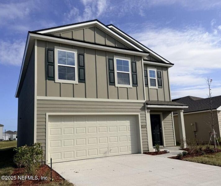Front exterior of a new home in The Arbors, Jacksonville, FL, highlighting curb appeal (Image 1). Front exterior of a new home in The Arbors, Jacksonville, FL, highlighting curb appeal (Image 1).