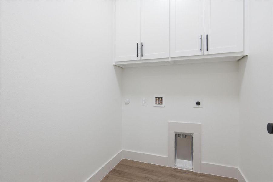 White cabinetry and durable flooring await your laundry appliances. White cabinetry and durable flooring await your laundry appliances.