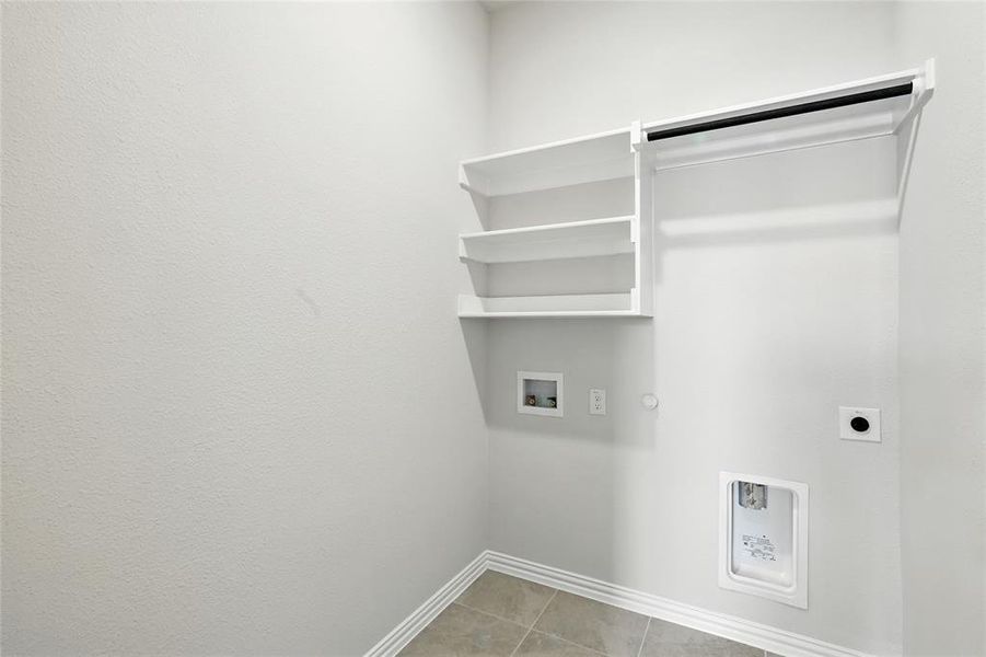 Laundry room featuring washer hookup, hookup for a gas dryer, hookup for an electric dryer, and light tile patterned flooring