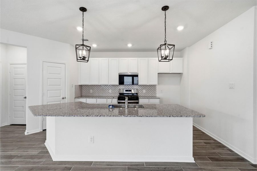 This spacious kitchen has it all—ample storage, generous counter space, and a layout that truly makes it the heart of the home. This spacious kitchen has it all—ample storage, generous counter space, and a layout that truly makes it the heart of the home.