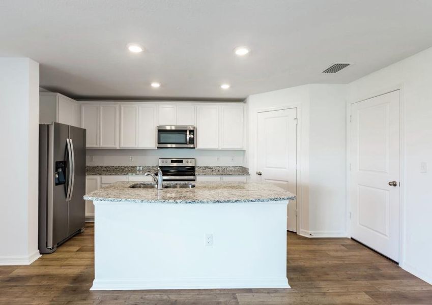 The kitchen is chef-ready with stainless steel appliances