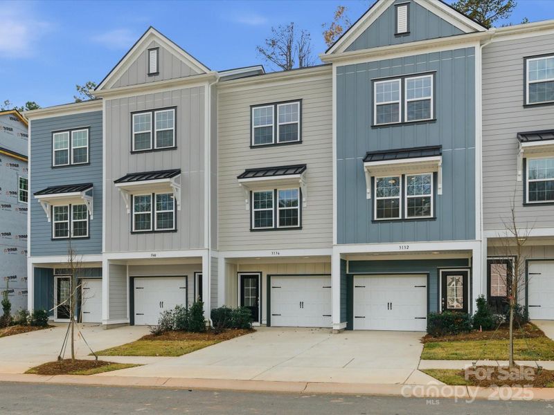 Front exterior of a new home in Sycamore Trail, Matthews, NC, highlighting curb appeal (Image 27).