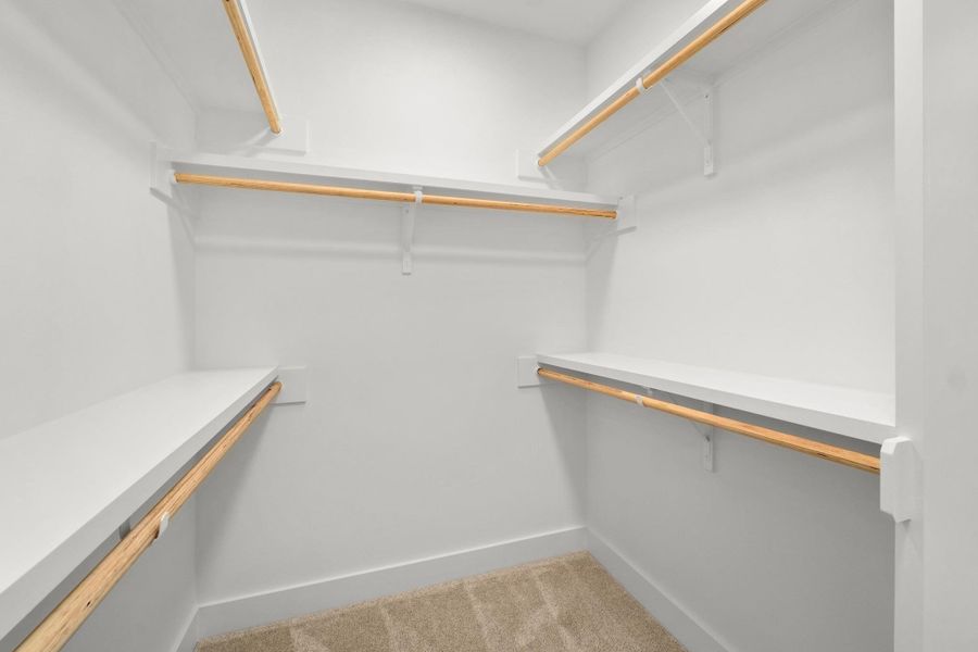 Walk in closet featuring light carpet