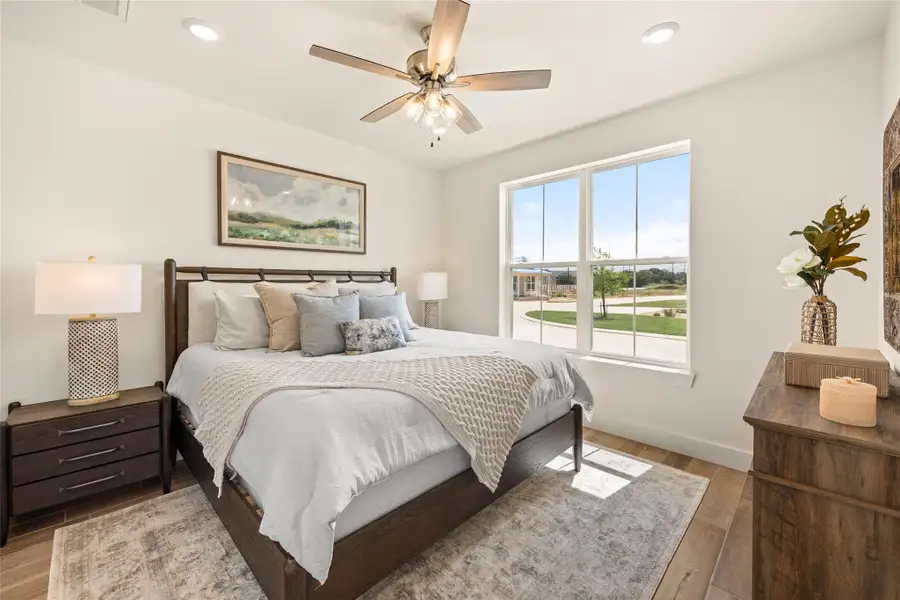 Bedroom with wood finished floors, a ceiling fan, and recessed lighting