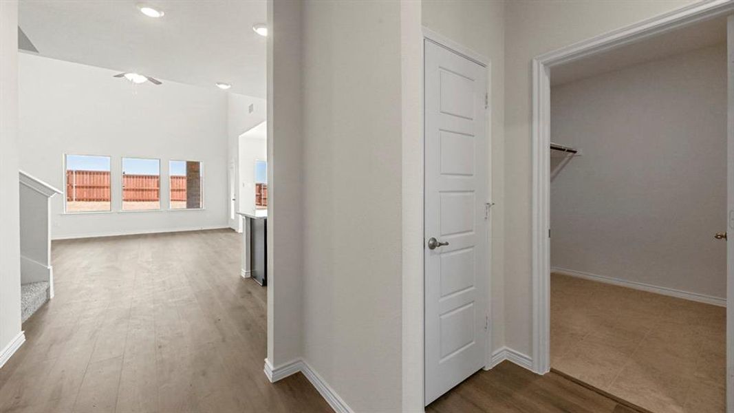 Corridor featuring light wood finished floors and recessed lighting
