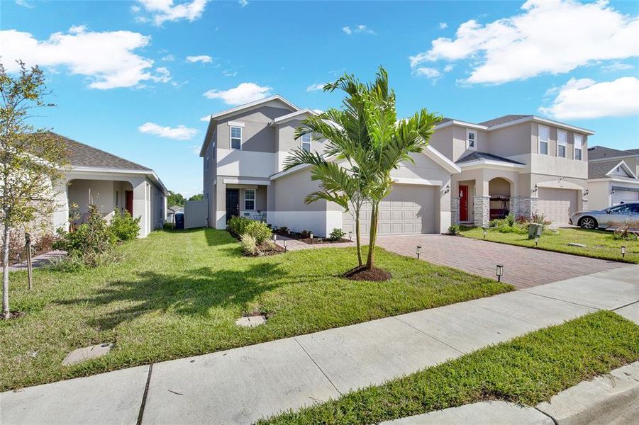 Front exterior of a new home in Horse Creek at Crosswinds, Davenport, FL, highlighting curb appeal (Image 28). Front exterior of a new home in Horse Creek at Crosswinds, Davenport, FL, highlighting curb appeal (Image 28).