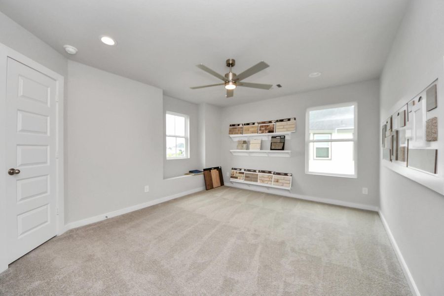 Generously sized secondary bedrooms featuring spacious closets, soft and inviting carpeting underfoot, large windows allowing plenty of natural light, and the added touch of privacy blinds for your personal retreat. Sample photo of completed home with similar floor plan. Actual colors and selections may vary.