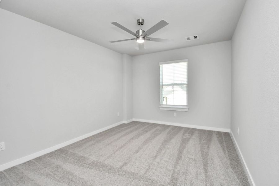 Secondary bedroom features plush carpeting, large windows that let in plenty of natural light, bright paint, and spacious closets. Sample photo of completed home with similar floor plan. Actual colors and selections may vary. Secondary bedroom features plush carpeting, large windows that let in plenty of natural light, bright paint, and spacious closets. Sample photo of completed home with similar floor plan. Actual colors and selections may vary.