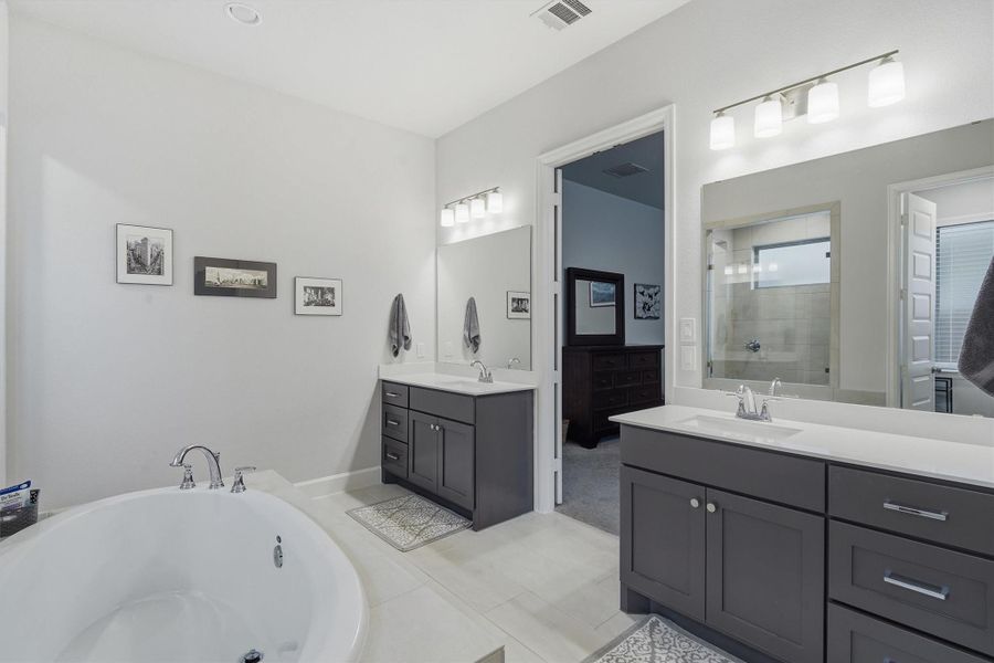 Separate double sinks, large mirrors and newly added drawer pulls Separate double sinks, large mirrors and newly added drawer pulls