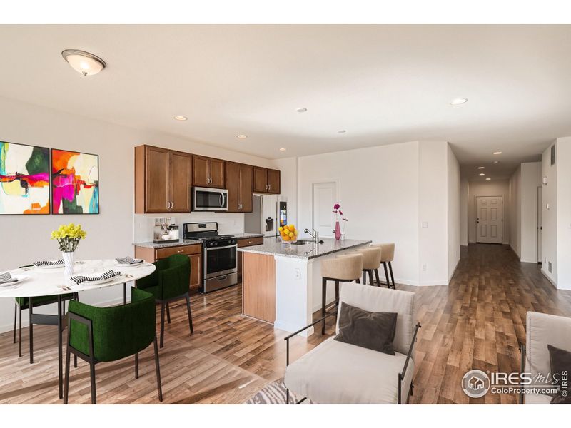 Home Under Construction. Photos are of the same Alpine floorplan, different home. Kitchen island and dining area Home Under Construction. Photos are of the same Alpine floorplan, different home. Kitchen island and dining area