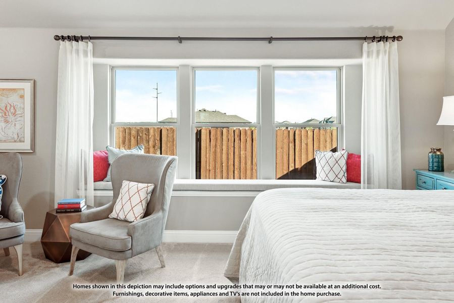 Bedroom with large bay window, built-in window seat, gray accent chair, and white bedding on carpet flooring Bedroom with large bay window, built-in window seat, gray accent chair, and white bedding on carpet flooring