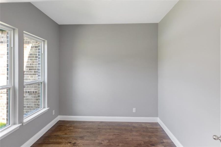 Spare room featuring dark hardwood / wood-style floors