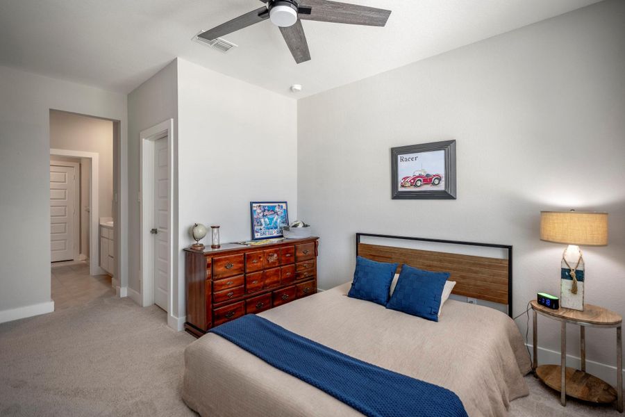 A walk-in closet and direct access to the Hollywood-style bathroom add everyday convenience, making this bedroom a comfortable retreat for guests or household members.