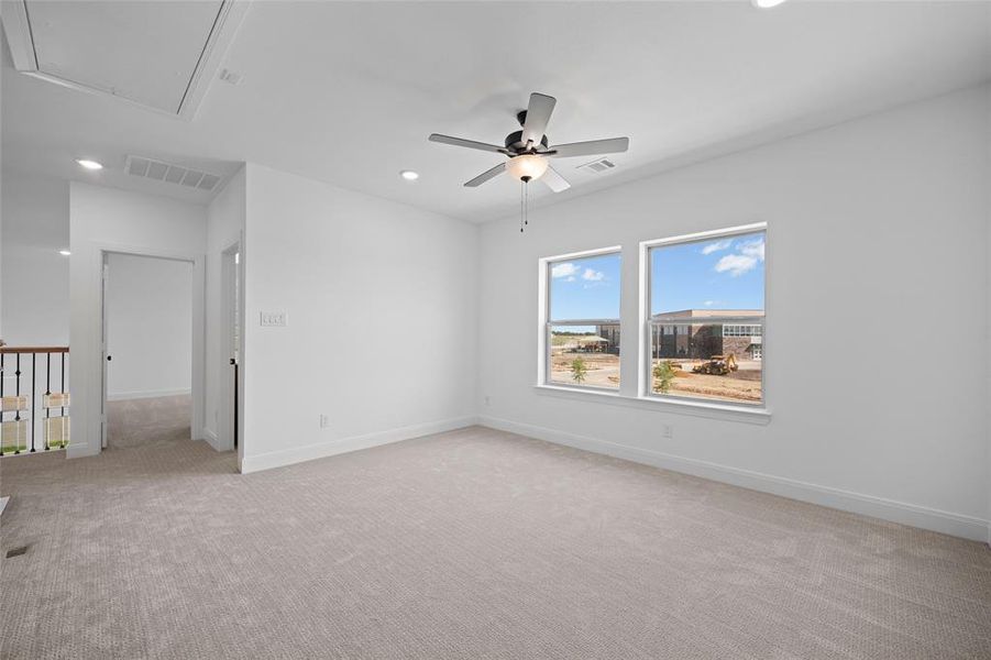 Carpeted empty room with ceiling fan