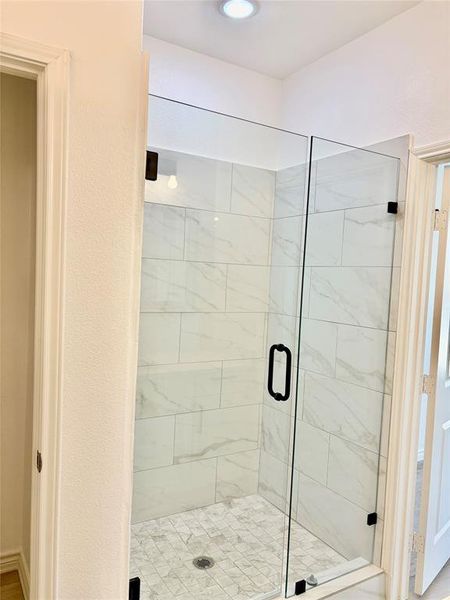 Full bathroom featuring a shower stall