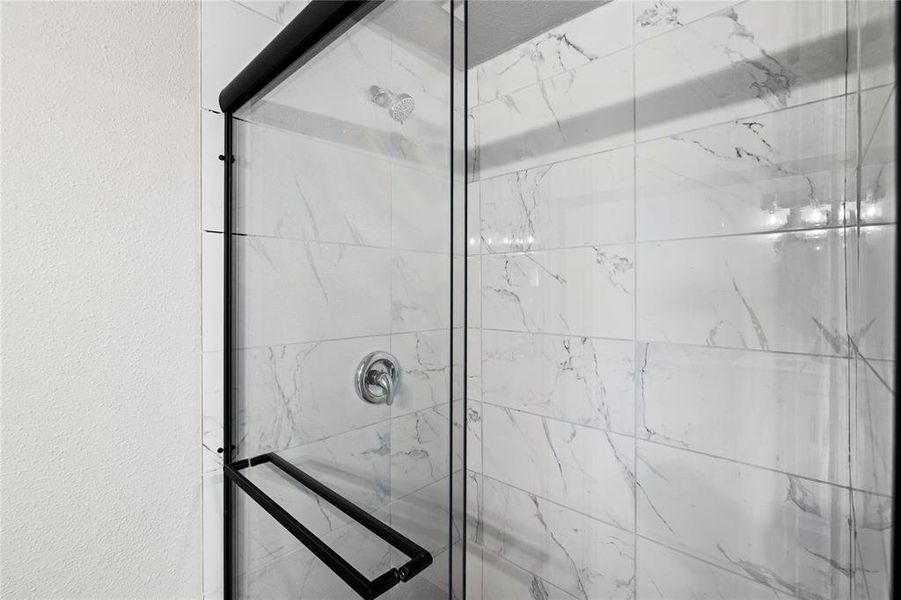 Bathroom featuring a marble finish shower