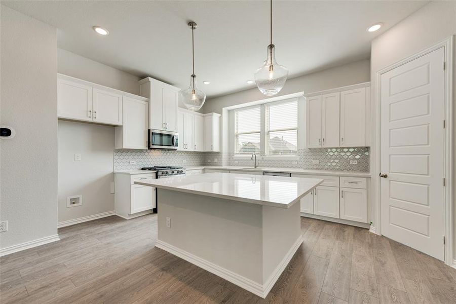 Kitchen with white cabinets and stainless steel appliances