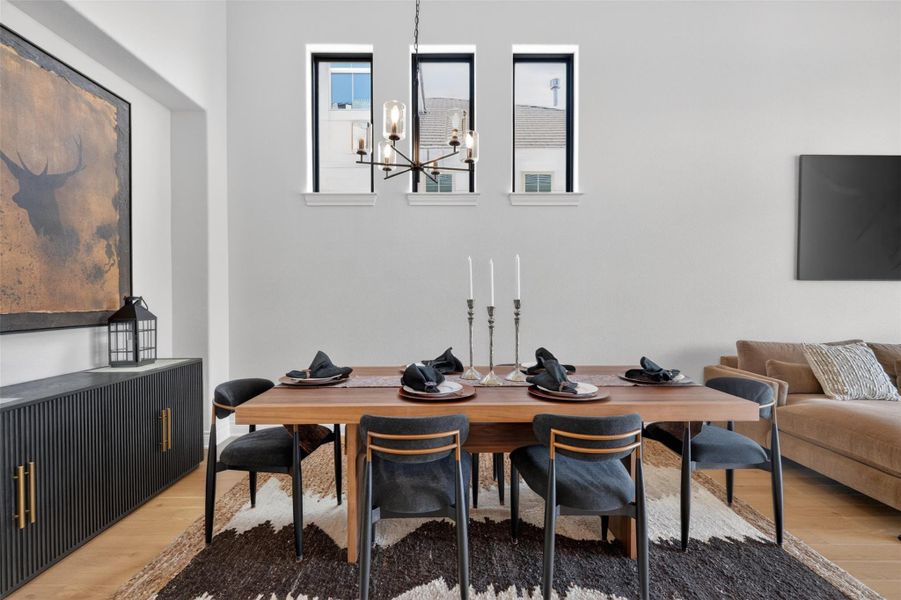 Clean lines and a modern chandelier elevate this spacious dining area, perfect for entertaining. Clean lines and a modern chandelier elevate this spacious dining area, perfect for entertaining.