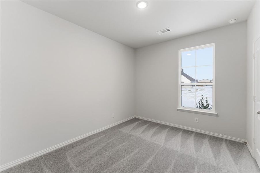 Unfurnished room with light colored carpet and baseboards Unfurnished room with light colored carpet and baseboards