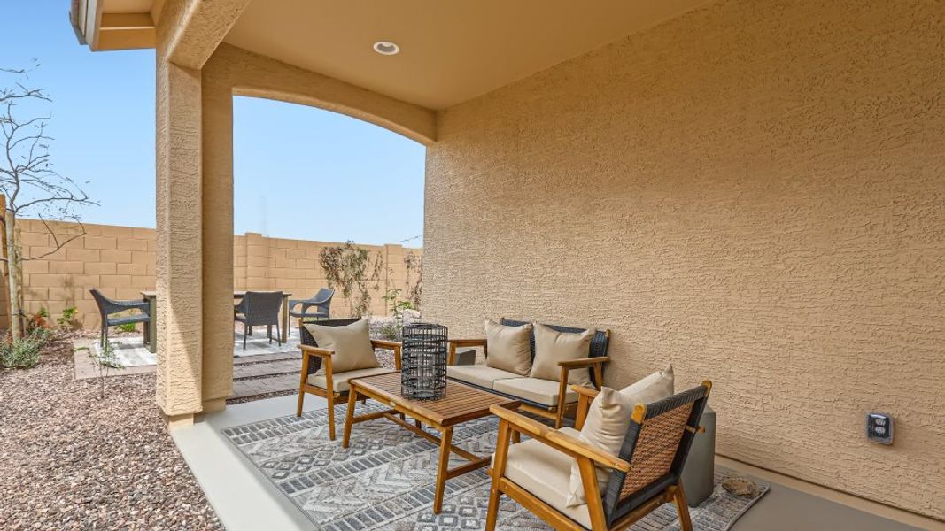 Covered patio styled with outdoor furniture