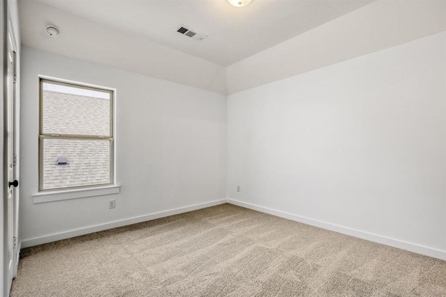 Spare room featuring baseboards and light colored carpet