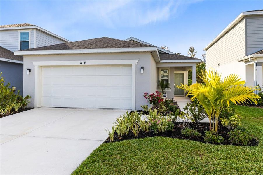 Front exterior of a new home in Cypress Hammock, Kissimmee, FL, highlighting curb appeal (Image 1).