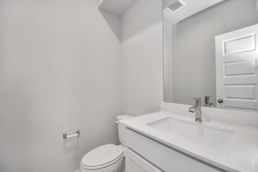 Sophisticated half bathroom adorned with contemporary finishes. The elegant 5-panel door welcomes you to a space where style meets functionality. Notice the sleek hardware accents that add a touch of modern charm. The vanity boasts light-colored countertops, beautifully complemented by a tasteful recessed lights, creating a well-lit and inviting atmosphere. Sophisticated half bathroom adorned with contemporary finishes. The elegant 5-panel door welcomes you to a space where style meets functionality. Notice the sleek hardware accents that add a touch of modern charm. The vanity boasts light-colored countertops, beautifully complemented by a tasteful recessed lights, creating a well-lit and inviting atmosphere.