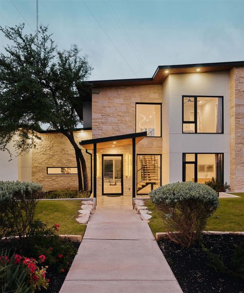 Modern facade with sleek lines and a welcoming entry beckons within. Modern facade with sleek lines and a welcoming entry beckons within.