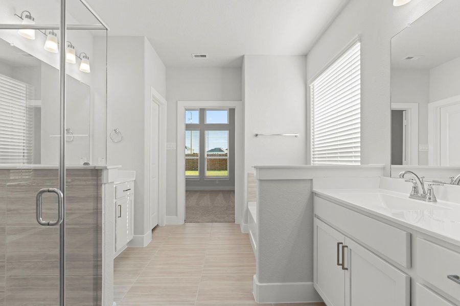 Every feature in this primary bath exudes sophistication—from the expansive dual vanities to the adjoining walk-in closet. Thoughtful design meets everyday functionality in this beautiful space. Every feature in this primary bath exudes sophistication—from the expansive dual vanities to the adjoining walk-in closet. Thoughtful design meets everyday functionality in this beautiful space.