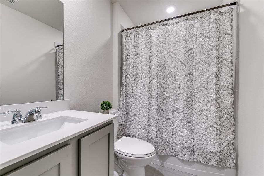 Hall bathroom offers shower / tub combo