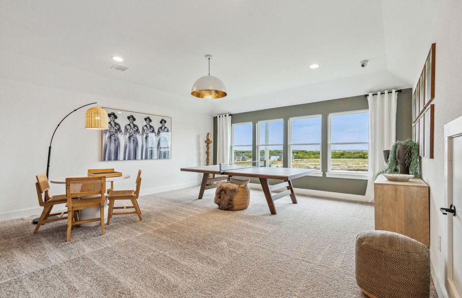 Spacious upstairs game room with large windows