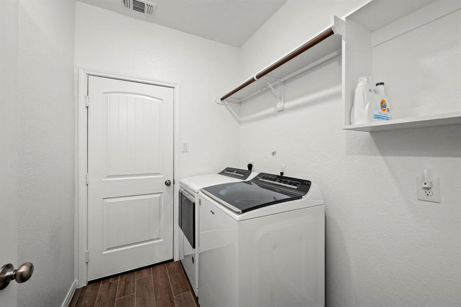 Oversized laundry/ mud room with shelving to accommodate all your laundry needs.