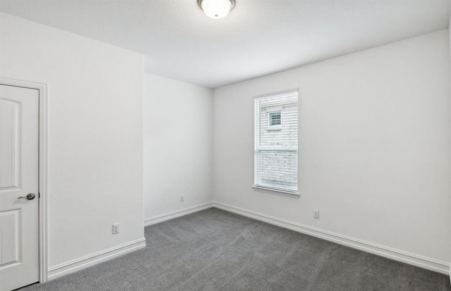 Spacious secondary bedroom with ample closet space*real home pictured