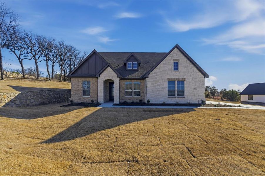 Front exterior of a new home in Oak Grove Addition, Springtown, TX, highlighting curb appeal (Image 21).