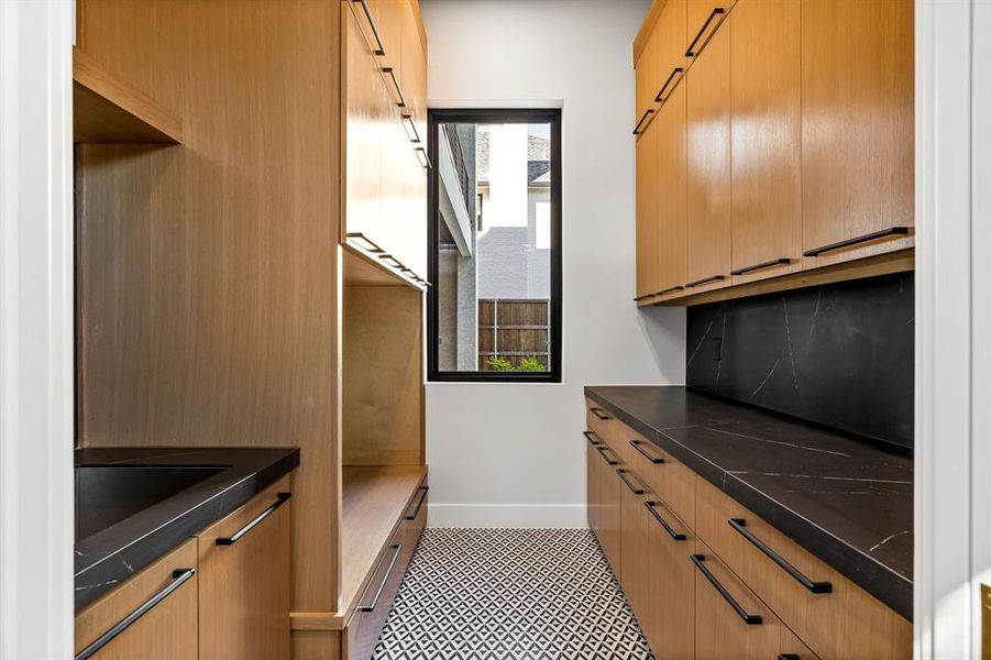 Kitchen featuring brown cabinetry and baseboards Kitchen featuring brown cabinetry and baseboards