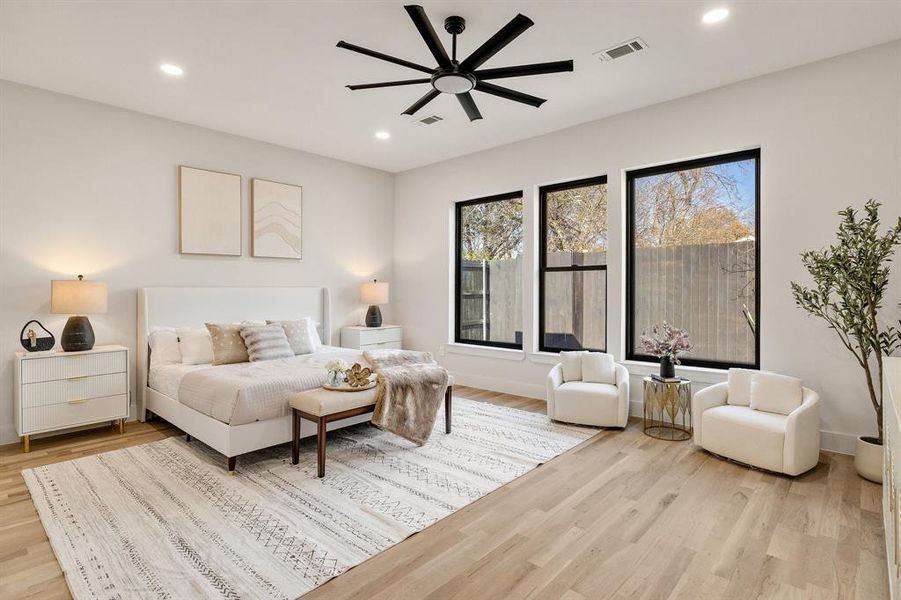 Bedroom with ceiling fan and light hardwood / wood-style floors