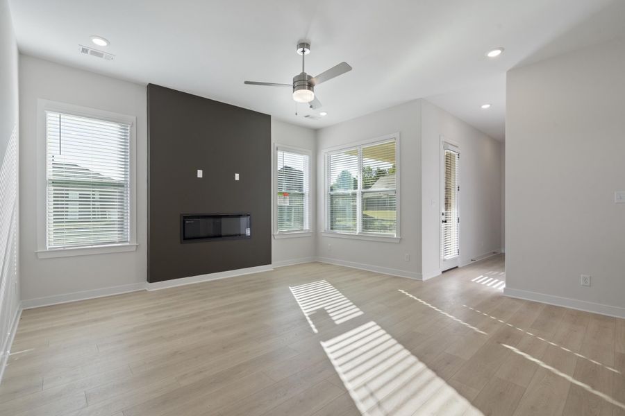 Recessed lighting, wood-finish flooring, ceiling fan, and large windows