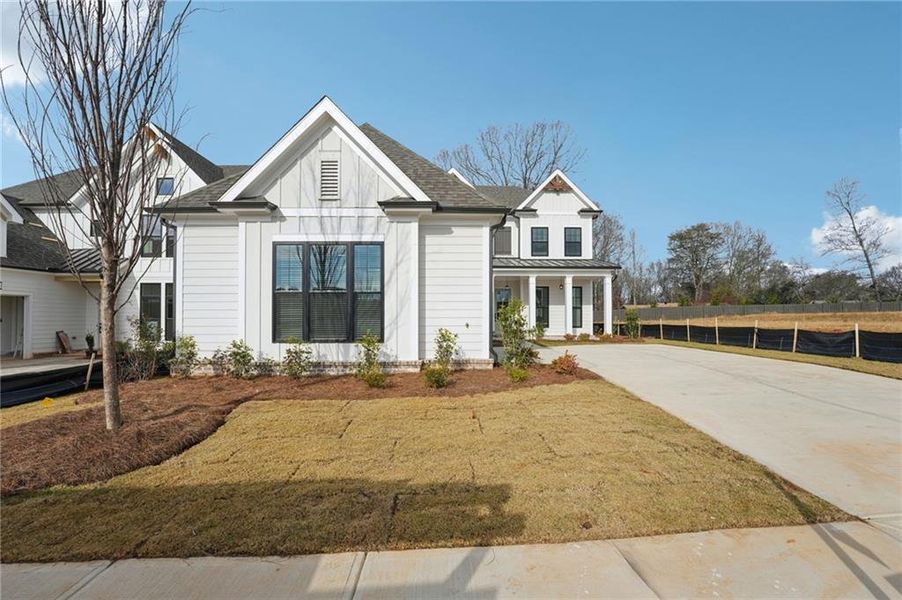 Front exterior of a new home in Promenade at Sawnee Village, Cumming, GA, highlighting curb appeal (Image 2). Front exterior of a new home in Promenade at Sawnee Village, Cumming, GA, highlighting curb appeal (Image 2).